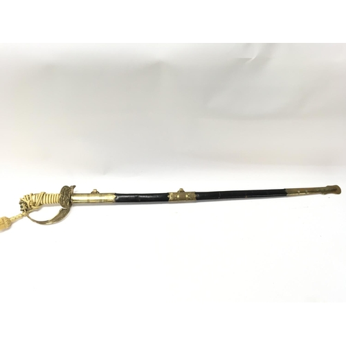 1495 - A 20th century naval officers dress sword with a brass hilt, lion head pommel , sword knot, unmarked... 