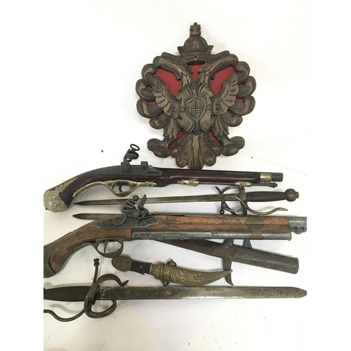 1544 - A collection of replica flintlock pistols and short swords.