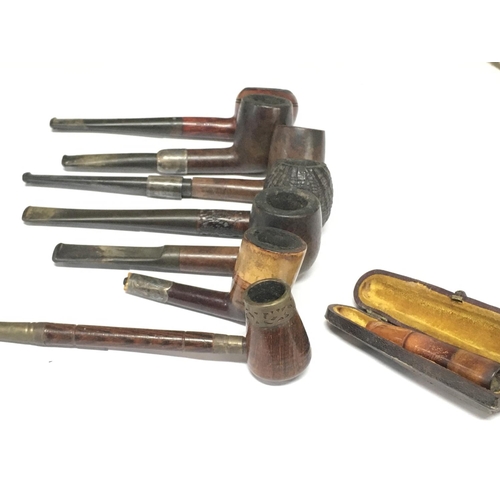 1825 - A Collection of pipes including a cased cheroot including some with silver hallmarked parts. Postage... 