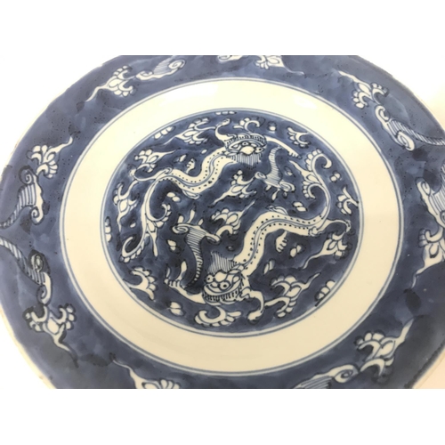 826 - Chinese blue and white dishes including a dragon dish and a Budai Dish. 19 and 21cm wide. This lot c... 