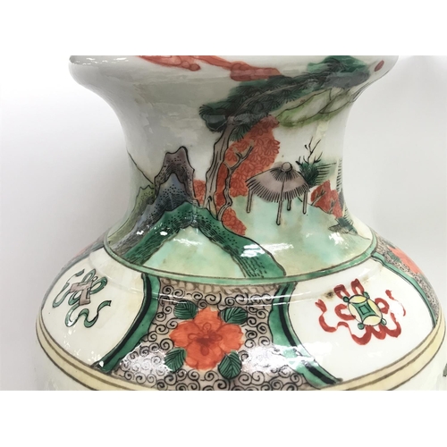 832 - A Chinese Famille Verte Wucai porcelain vase with a six character mark at the base. 43cm tall. This ... 