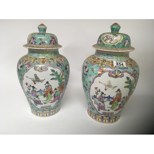 854 - A pair of Chinese export porcelain jars and covers 20th century painted with panels of figures withi... 