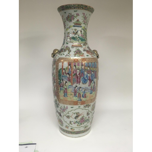 858 - A large canton vase decorated with figures birds butterflies and flowers 62 cm . Hairline crack.