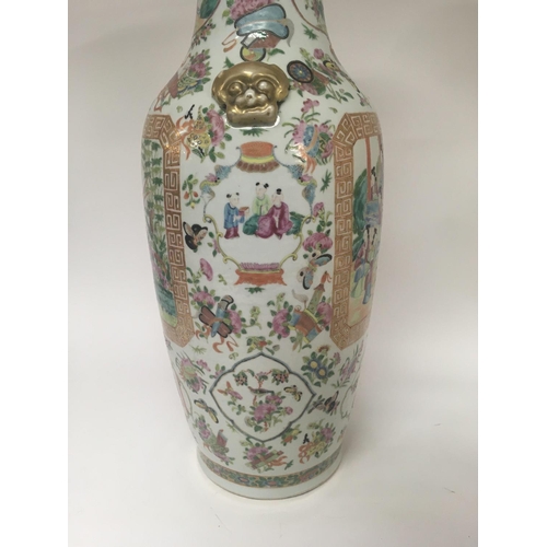 858 - A large canton vase decorated with figures birds butterflies and flowers 62 cm . Hairline crack.