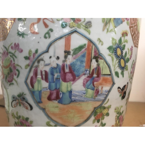 858 - A large canton vase decorated with figures birds butterflies and flowers 62 cm . Hairline crack.