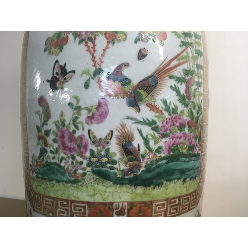 858 - A large canton vase decorated with figures birds butterflies and flowers 62 cm . Hairline crack.