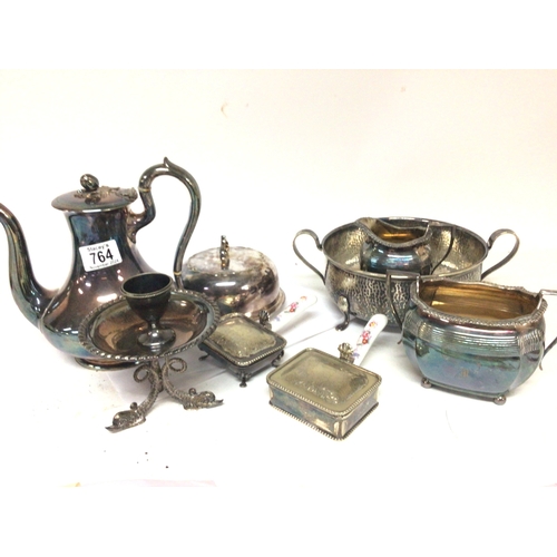 764 - A collection of silver plate a muffin dish tea pot sugar bowl and cream jug and other oddments.