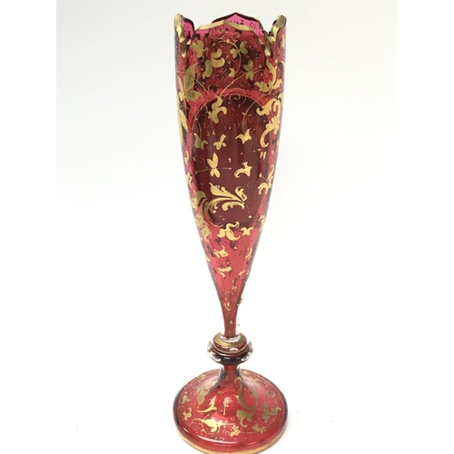 1084 - A Victorian Bohemian Cranberry portrait vase with gilt decoration , 22cm tall. This lot cannot be po... 