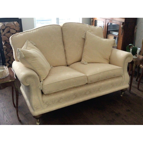 1319 - A fine quality two seater sofa upholstered in yellow floral fabric with two scatter cushions on maho... 