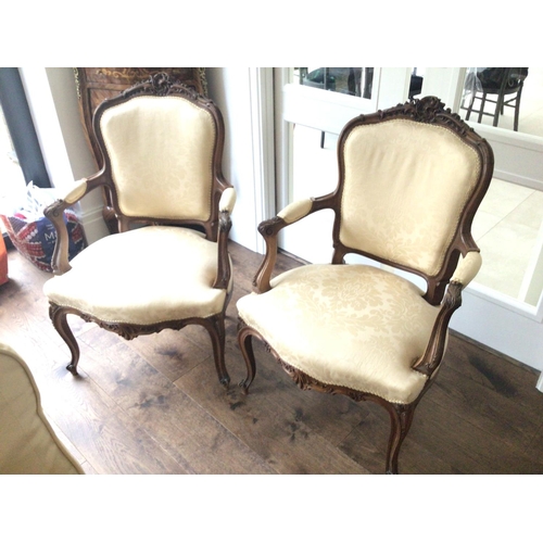 1321 - A pair of quality French Louis XVI style carved wood open arm chairs the top rail with folate scroll... 