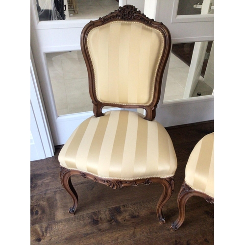 1322 - A pair of conforming French Louis XVI style matching chairs with carved top rail tastefully upholste... 