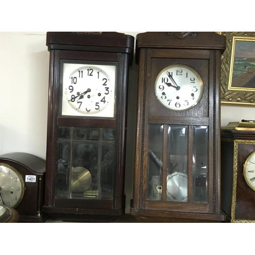 1403 - Two wall clocks. Both approximately 86cm tall and 32cm wide, Postage D.