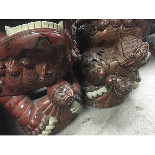 1407 - A large pair of carved wooden dogs of Fo .