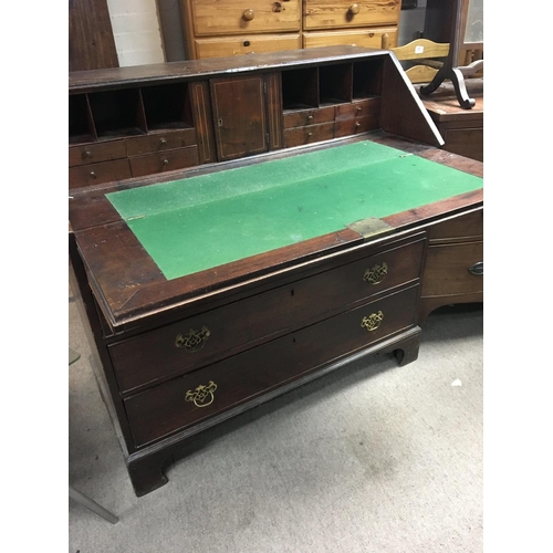 1408 - A George III mahogany bureau with a well fitted with small drawers and hidden compartments above fou... 