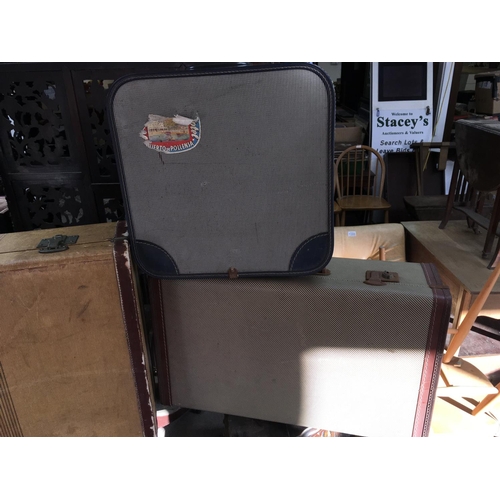 2100 - Three vintage suit cases. Largest is 76cm wide by 46cm tall.