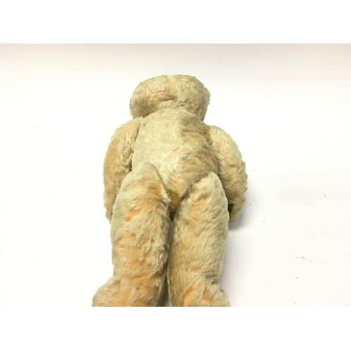 2107 - A vintage teddy bear. Approximately 18 inches tall. Postage B