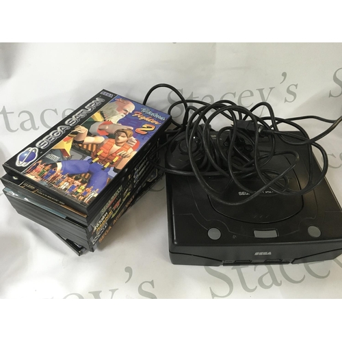 2110 - Two playworn Sega saturns with games.