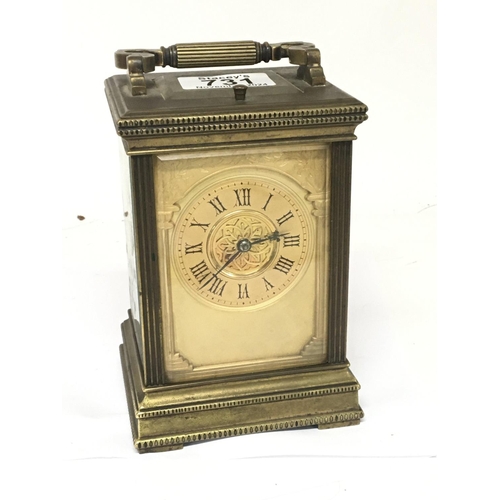 815 - An Edwardian brass cased carriage clock strike repeat with a gilded dial the movement striking on go... 