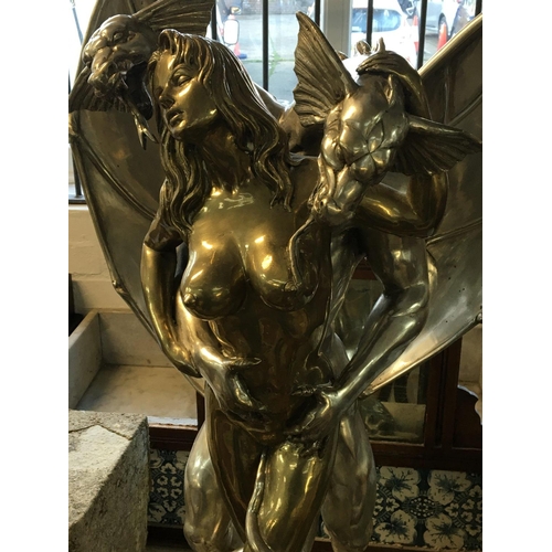 837 - A Modern Contemporary erotic bronze statue of nude female embraced by a two headed dragon. The sculp... 