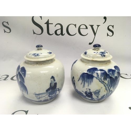 928 - A pair of blue and white ginger jars decorated with figures in a landscape setting, four character m... 