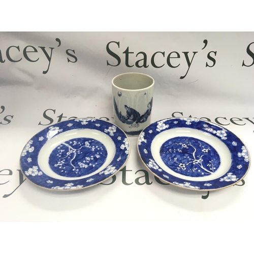 930 - A blue and white brush pot and two dishes decorated with prunus blossom, approx diameter 23cm. Shipp... 