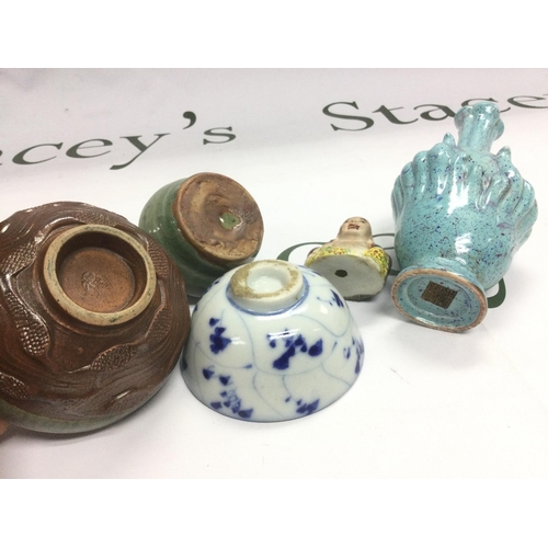 938 - Five small Oriental ceramics comprising tea bowls, vases etc. Shipping category D.