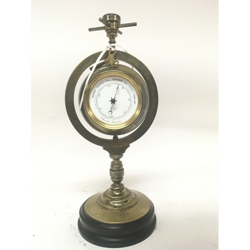 120 - A Victorian brass clock barometer with a revolving Spherical ball. No Reserve. Height 33cm. With key