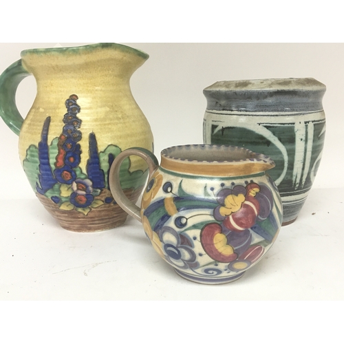 187 - A hand painted Crown Devon jug a Poole pottery jug and a contemporary ceramic vase with marks to the... 