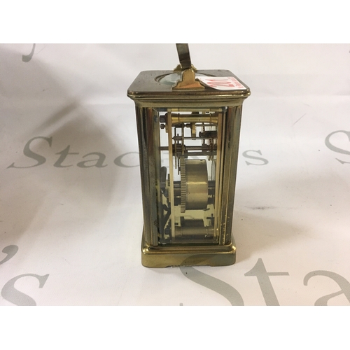 201 - A Victorian antique clock made from brass which has Roman numerals and a visible mechanism.