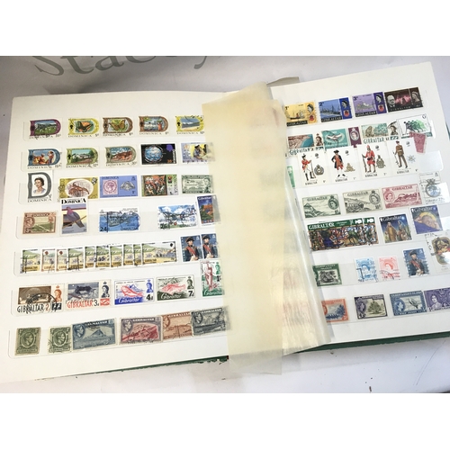 211 - World Stamp albums including used and unused stamps from Barbados, Cyprus, Gibraltar, UK, Canada etc