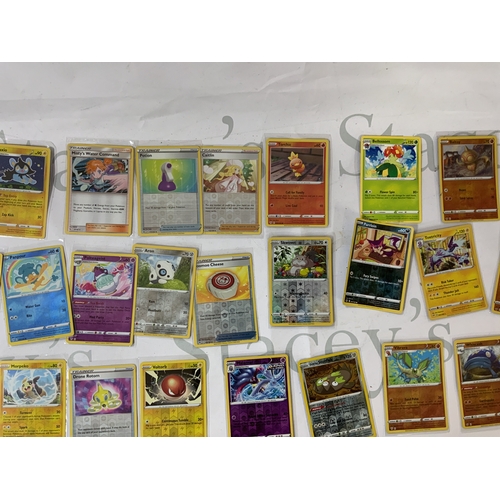 285 - A collection of Pokemon cards, including a sealed Sun and Moon Cosmic Eclipse Unseen Depths theme de... 