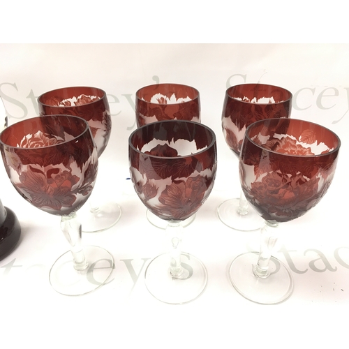 319 - A set of cameo ruby flash wine glasses and a pitcher.