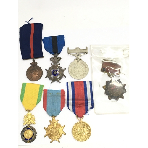 411 - A Collection of military medals including a China 1954 merit, Polish peoples public medal, Belgium T... 