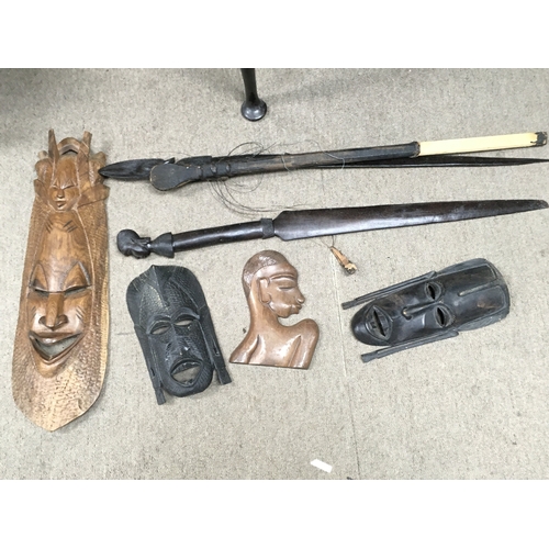 42 - A Collection of African wooden masks, spears etc