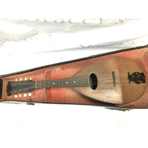 598 - A cased mandolin , 60cm long approximately