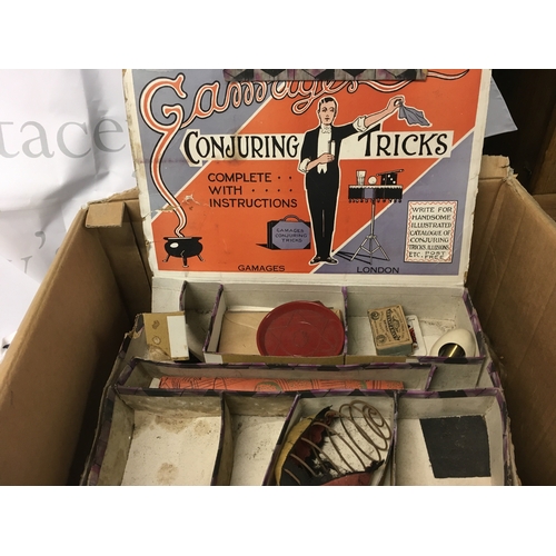 610 - A collection of antique toys and games including Gamages Conjuring Tricks, a battery operated Patrol... 