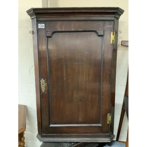 637 - An Early George III oak corner cabinet.