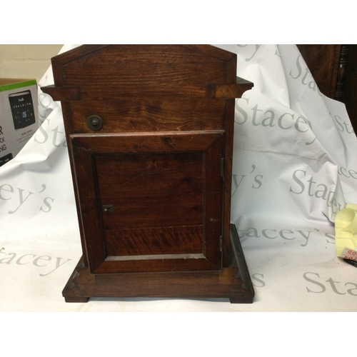 698 - A Walnut cased early 20th century mantel clock. Height 46cm