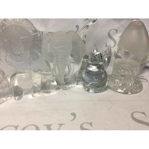 704 - A collection of glass decanters, glass items and glasses, some handmade and in the shape of animals.