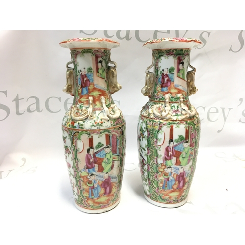 738 - A pair of 19th century Chinese Cantonese Famille Rose vases decorated with Chinese figures. 26cm tal... 