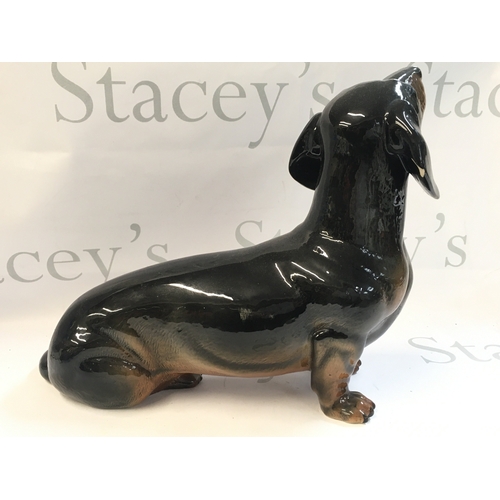 99 - A Beswick porcelain Dachshund dog , 26 cm tall 30cm long