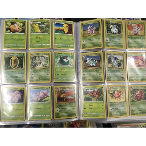 12 - A collection of modern pokemon cards, in 7 albums and a tin.