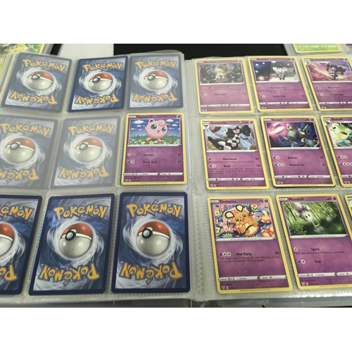 12 - A collection of modern pokemon cards, in 7 albums and a tin.