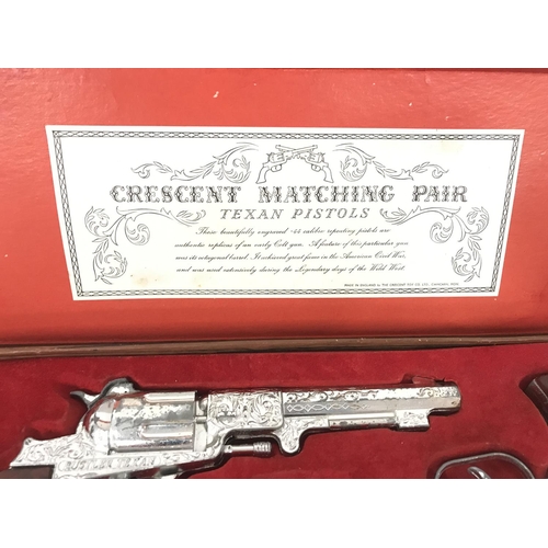 27 - A Boxed Crescent Toys Matching Pair Of Texan Pistols