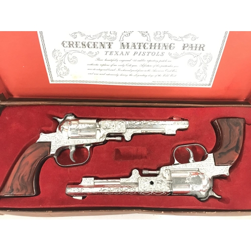 27 - A Boxed Crescent Toys Matching Pair Of Texan Pistols