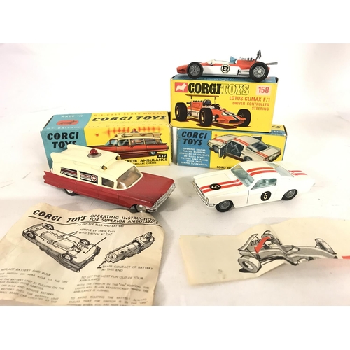 344 - A Boxed Corgi Superior Ambulance #437. A Lotus-Climax F/1 #158. And a Ford Mustang #325.