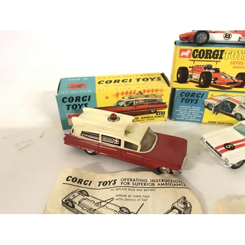 344 - A Boxed Corgi Superior Ambulance #437. A Lotus-Climax F/1 #158. And a Ford Mustang #325.