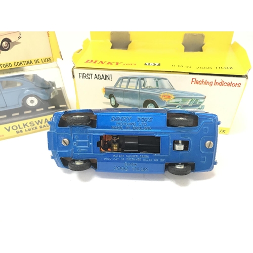 69 - A Boxed Dinky Ford Cortina De Luxe #159. A Volkswagen De Luxe Saloon #129 and a B.M.W 2000 Toluca #1... 