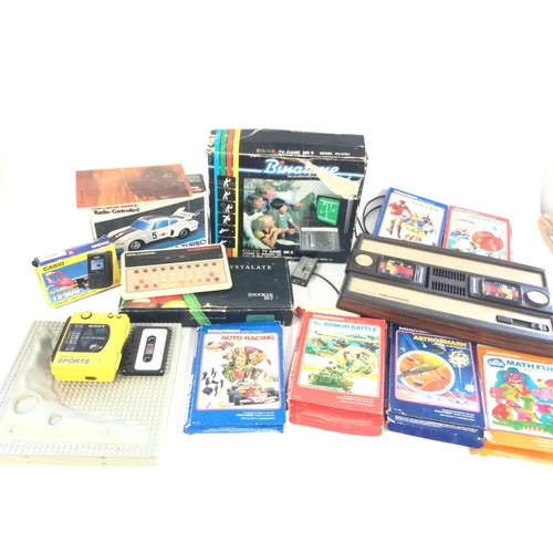 711 - A box containing a Mattel Intellivision plus 6 games, also a Mattel Brain Baffler, a Sony Walkman Sp... 