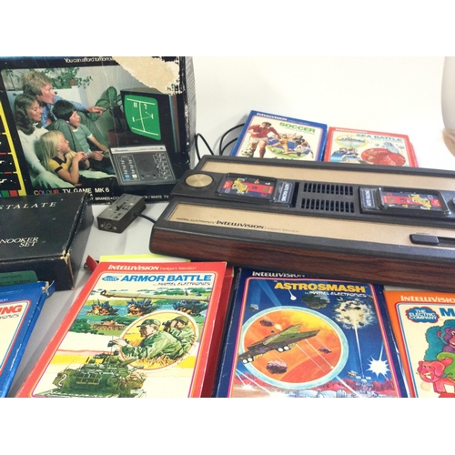 711 - A box containing a Mattel Intellivision plus 6 games, also a Mattel Brain Baffler, a Sony Walkman Sp... 